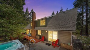 Une maison moderne dotée d’un jacuzzi, d’un espace salon extérieur et d’une terrasse.