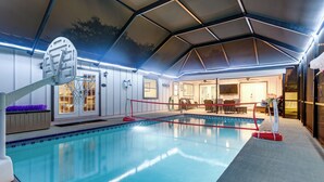 An indoor swimming pool with a basketball hoop, a covered seating area, and a view of the interior. - Luxe Jupiter Home w/ Pool House, Near Golf & Beach (Jupiter)