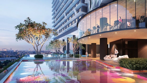 A modern hotel with a rooftop pool reflecting the cityscape, a glass facade, and a landscaped area with trees. - KL Gateway Premium Residences by MOKA (Kuala Lumpur)