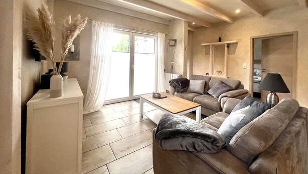 A modern living room with a sofa, a coffee table, and a lamp.