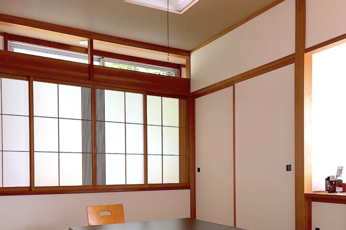 Ein traditioneller japanischer Raum mit Tatami-Böden, einem niedrigen Tisch und Schiebetüren.