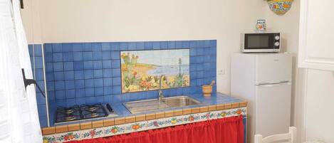 Fridge, microwave, coffee/tea maker, cookware/dishes/utensils