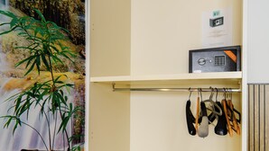 A room with a wall-mounted safe, a hanging rack with kitchen utensils, and a framed certificate on the wall. - Lovely Bed and Breakfast in Center of Sorrento (Sorrento)