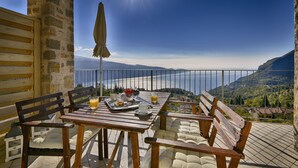 A terrace with a table set for breakfast, overlooking a scenic mountain view. - Apartment with breakfast - Only Adults (Tignale)