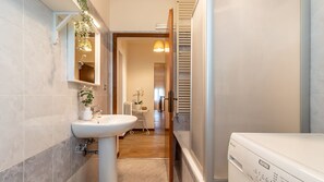 Enjoy a refreshing shower in this bathroom with a heater and modern sink.