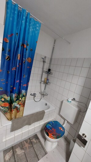 Bathtub, hair dryer, towels, soap