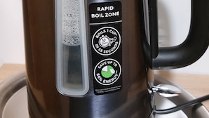 A stainless steel electric kettle with a black handle and a transparent water level indicator. It has a label indicating it is a 'Rapid Boil Zone' and claims to boil 1 cup in 55 seconds, saving up to 66% energy. - 5 km from the center, 1 km from the train station and 11 km from Baden-Airpark (Baden-Baden)