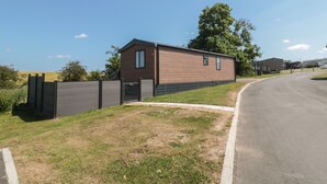 A modern single-story building with a flat roof, a small window, and a door.
