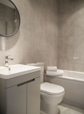 Combined shower/bathtub, towels, soap, toilet paper