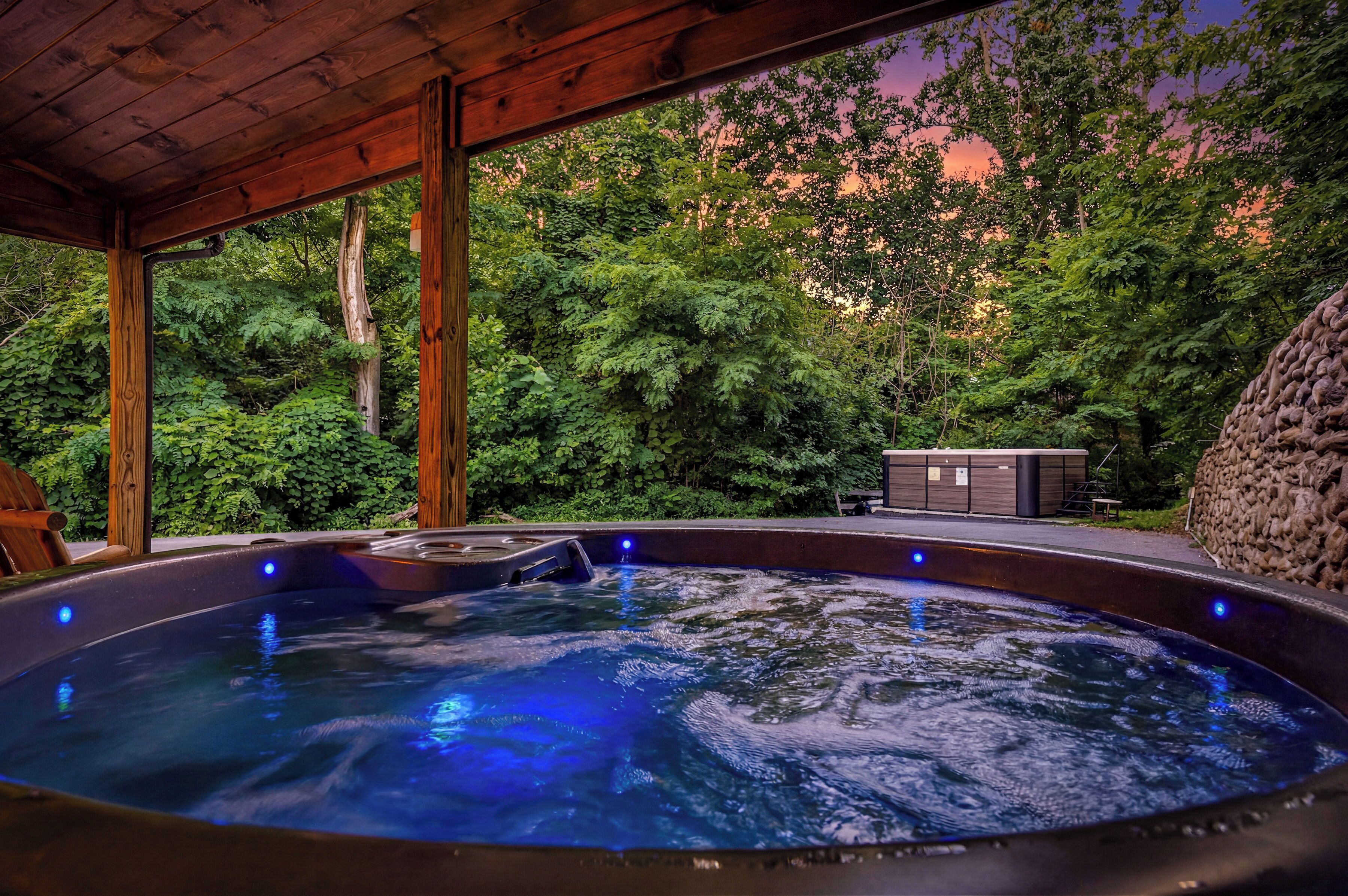 A hot tub with a wooden roof and a view of a lush garden.