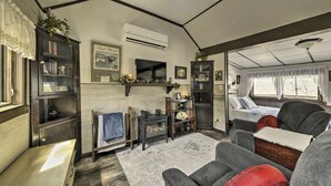 A cozy living room with a fireplace, a television, and a comfortable seating area.