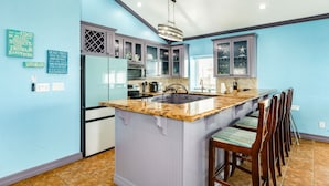 A kitchen with a central island, a refrigerator, a microwave, and a sink. - Starfish Beach Gem - Right ON Beach & So Lovely! (Surfside Beach)