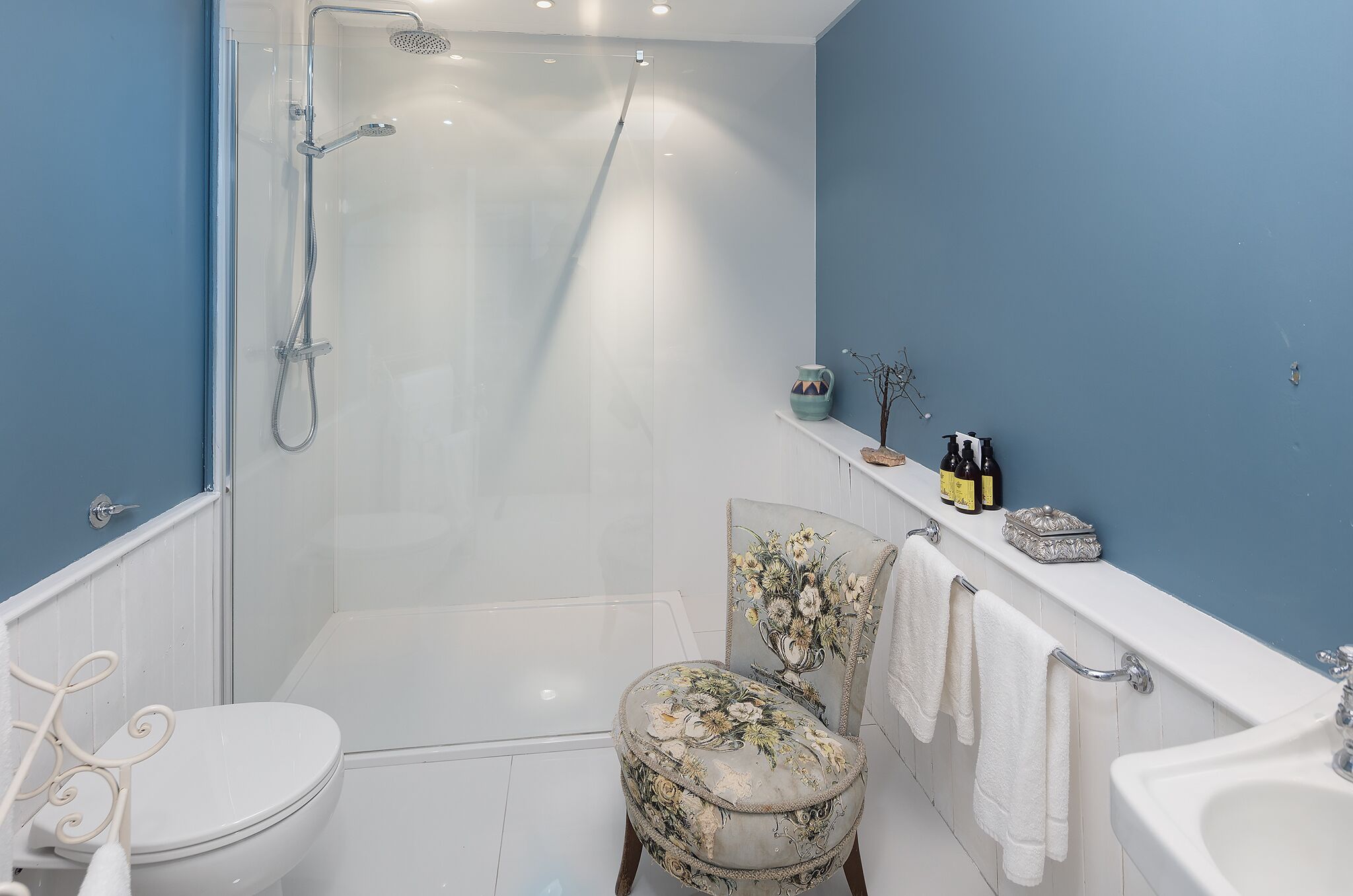 A bathroom with a shower, toilet, and sink.