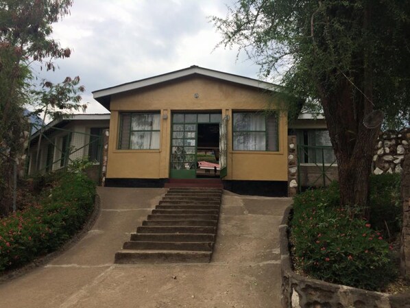 A two-story building with a flat roof and a central entrance.