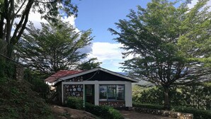 A small house with a stone facade, a red roof, and a large window. - Sego Safari Lodge (Eldoret)