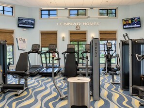 A gym with treadmills, weight machines, and a wall clock.