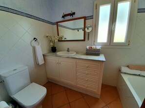 Bathtub, hair dryer, towels, soap