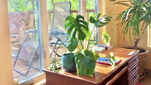 A room with a large window, a wooden desk, and a potted plant. - Heaven on Earth Retreat's Sun Studio in Prescott's Gorgeous Granite Dells (Prescott)
