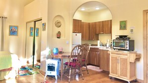 A compact kitchen with wooden cabinets, a built-in oven, and a microwave. - Heaven on Earth Retreat's Sun Studio in Prescott's Gorgeous Granite Dells (Prescott)