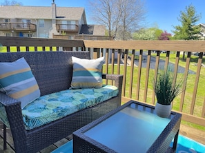 Relax on the balcony with a wicker sofa and enjoy the view of the surrounding neighborhood.
