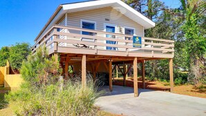 A two-story house with a balcony, a covered porch, and a driveway. - 5041 The Captains Quarters *1 Block to Boat Access (Kill Devil Hills)