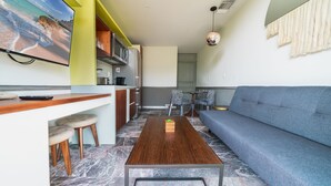 A modern living space with a kitchen, dining area, and seating area. - Condo Jade - Singular Joy Residences (Playa del Carmen)