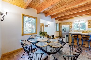 Enjoy meals in this dining area with a large round table and comfortable seating for all.