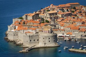 Explore the historic town's medieval and Renaissance architecture, surrounded by a tranquil sea and picturesque buildings with red-tiled roofs.