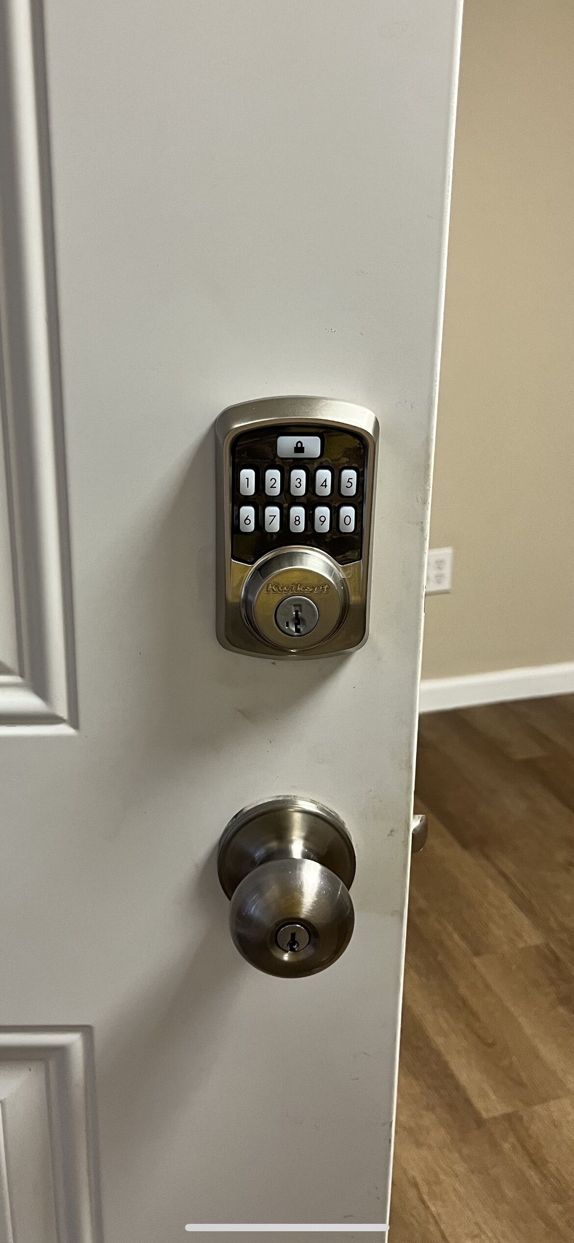 A door with a numeric keypad lock and a keyhole.