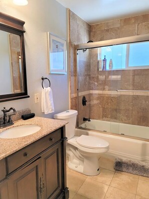 Combined shower/bathtub, hair dryer, towels, soap