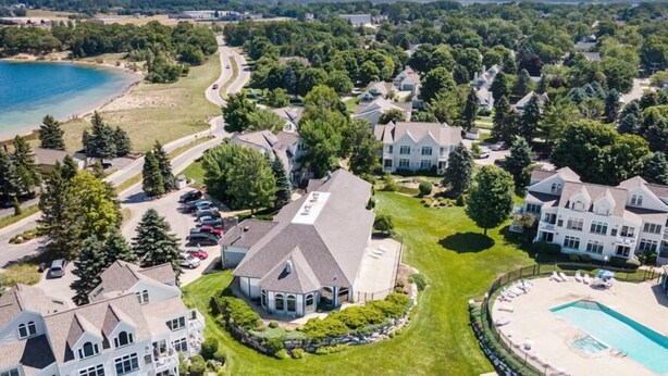 A residential area with houses, a swimming pool, and a beach. - Updated, LK MI View - Pet Friendly! (Manistee)