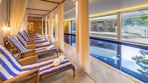 A spa area with lounge chairs and a pool.