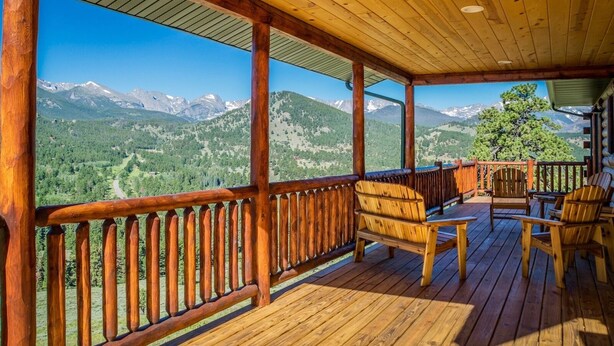 A wooden deck with a view of a mountainous landscape. - Armstrong Lxury Vacation Home at Windcliff (Estes Park)