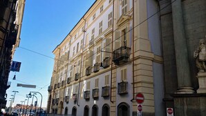 A historic building with multiple floors, balconies, and a classical architectural style. - Eurovision Song Contest downtown Turin (Torino)