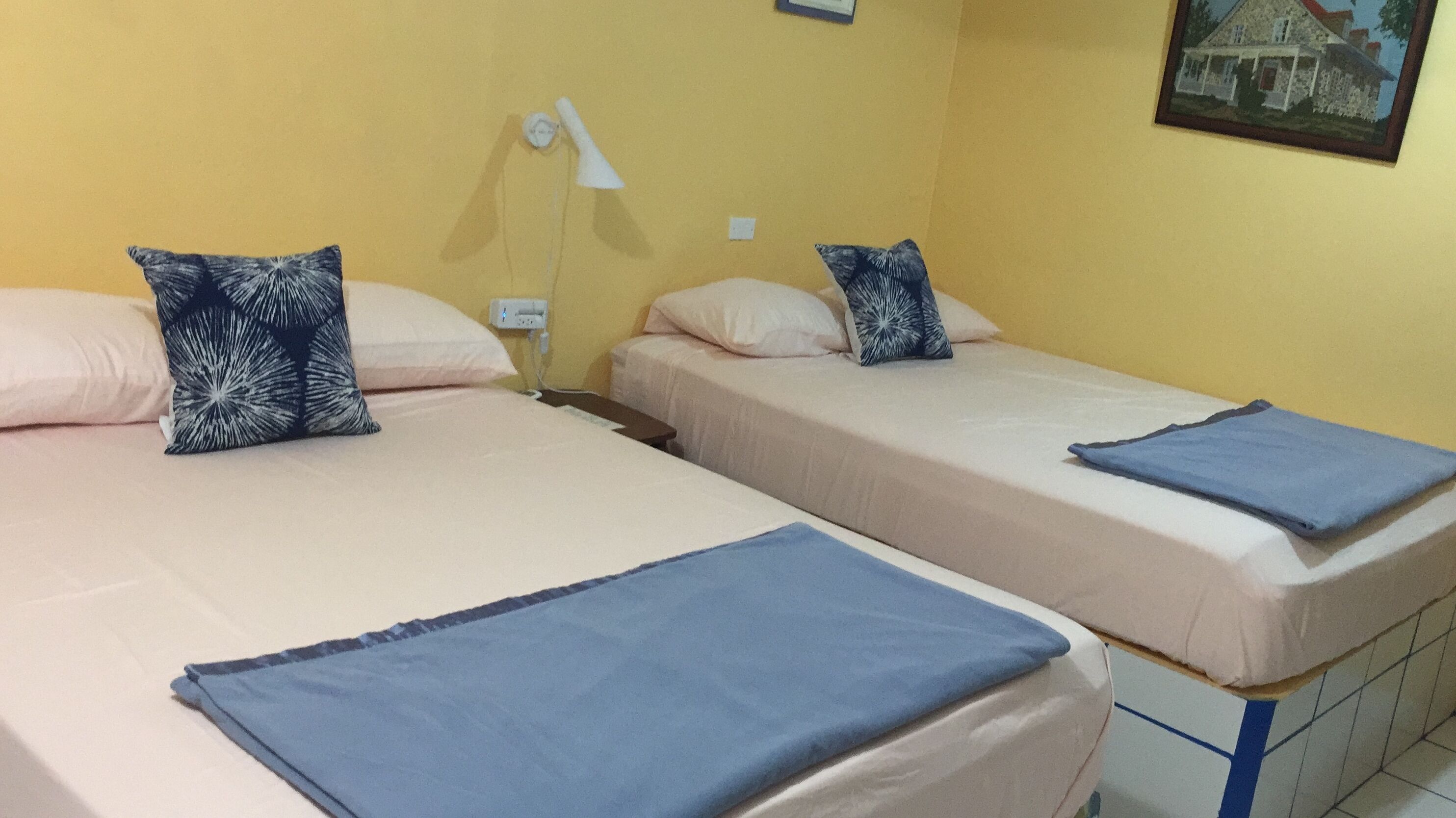 Two single beds with matching pillows and a nightstand.