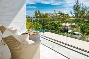 Relax on the balcony with a clear view of the surrounding landscape, featuring lush greenery and a glimpse of the neighborhood.