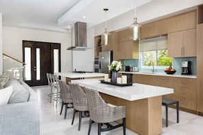 Enjoy cooking in this well-equipped kitchen with a spacious island, oven, and large refrigerator.