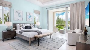 A bedroom with a bed, bedside tables, a bench, a sofa, and a view of the outdoors. - Salt Air and Second Wind Villas (Leeward)