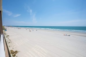 A beach with a clear sky and calm sea.
