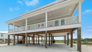 A beachfront house with a balcony, wooden deck, and a covered patio area. - Private beach/Luxury home/Private pool (Gulf Shores)
