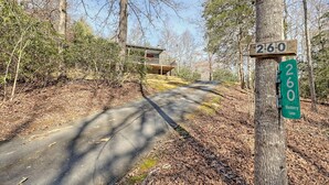 A road sign indicating '260 Blueberry Lane' with a house in the background. - Beary’s Den where Chic meets Country in this Cozy Cabin (Murphy)