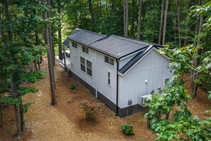 A two-story house with a sloped roof, surrounded by a wooded area. - Pool l Hot Tub, Sunrise & Mountain VIEWS (Mentone)