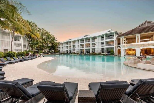 Relax by the pool surrounded by comfortable lounge chairs.