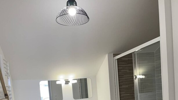 A modern bathroom with a white vanity, a large mirror, and a glass shower enclosure. - New appartment near the center for 6 people with car park (LACANAU OCEAN)