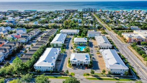 An aerial view of a residential area with houses, a swimming pool, and a road. - Family Friendly, Close to Beach and Shops (Destin)