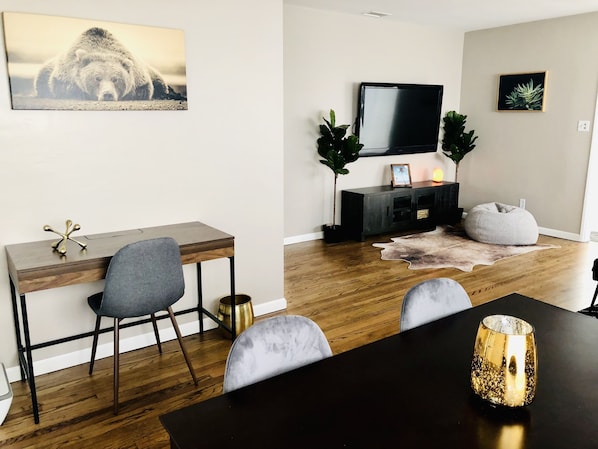 Work, dine, and unwind in this well-organized space with a desk, dining table, and comfortable seating.