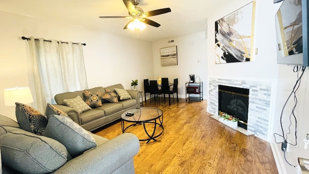 A living room with a sofa, coffee table, and fireplace. - Downtown of Pigeon Forge. Cozy 1 bed 1 bath condo <br>208 (Pigeon Forge)