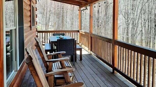 A wooden deck with benches and a table, overlooking a forest. - Wild Peace  Secluded in Nature Fireplace, Pit (Waynesville)