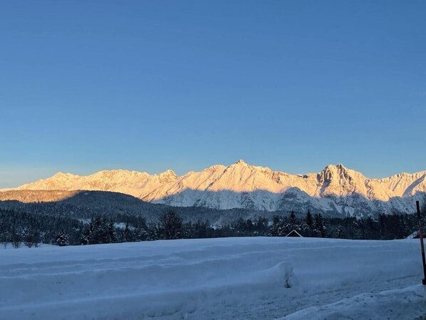 A snowy mountain landscape with clear skies.