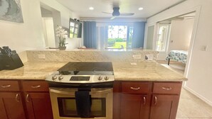 A kitchen with a built-in oven, a stovetop, and a microwave.
